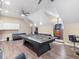 Spacious game room with hardwood floors, ping pong table, and two arcade games, perfect for entertaining guests at 6161 Blakeford Dr, Windermere, FL 34786