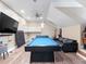 Upstairs game room with a pool table, arcade games, TV, and comfortable seating for Gathering fun at 6161 Blakeford Dr, Windermere, FL 34786