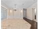 Bright living room featuring tile flooring, chandelier, and French doors leading to outdoor space at 6161 Blakeford Dr, Windermere, FL 34786