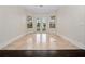 Bright living room featuring large windows and French doors, which provide ample natural light and scenic views at 6161 Blakeford Dr, Windermere, FL 34786