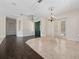 Inviting living room with hardwood and tiled flooring, chandelier, and decorative ceiling trim at 6161 Blakeford Dr, Windermere, FL 34786