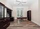 Well appointed office space with sleek hardwood floors, a large desk, and built in cabinets for optimal storage at 6161 Blakeford Dr, Windermere, FL 34786