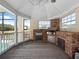 This screened outdoor kitchen boasts stainless appliances, a brick surround, and beautiful views at 6161 Blakeford Dr, Windermere, FL 34786