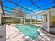 Screened-in pool with attached spa, surrounded by brick pavers and offering serene outdoor living at 6161 Blakeford Dr, Windermere, FL 34786