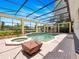 Screened-in pool with a spa and poolside fire pit, perfect for year-round outdoor enjoyment at 6161 Blakeford Dr, Windermere, FL 34786