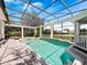 Sparkling in-ground pool with screened enclosure and brick-paver patio perfect for relaxation and recreation at 6161 Blakeford Dr, Windermere, FL 34786