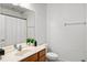 Simple bathroom featuring a single sink vanity and a shower with a white curtain at 6205 Miramonte Dr # 103, Orlando, FL 32835