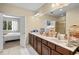 Spacious bathroom with double vanity, generous counter space, and access to bedroom and shower at 6205 Miramonte Dr # 103, Orlando, FL 32835
