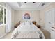 Bright bedroom featuring neutral walls, a ceiling fan, and large window providing natural light at 6205 Miramonte Dr # 103, Orlando, FL 32835