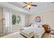 Bright bedroom featuring a ceiling fan, large window with curtains, and comfortable furnishings at 6205 Miramonte Dr # 103, Orlando, FL 32835