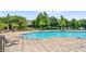 Community pool with stylish lounge chairs and lush landscaping for relaxation at 6205 Miramonte Dr # 103, Orlando, FL 32835