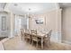 Formal dining area featuring a white table set for eight, complemented by stylish wainscoting and a decorative light fixture at 6205 Miramonte Dr # 103, Orlando, FL 32835