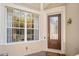 Elegant front entrance showcasing a decorative glass door and a large window allowing ample natural light at 6205 Miramonte Dr # 103, Orlando, FL 32835