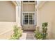 Inviting villa entrance with lush landscaping framing a brick path to the elegant front window at 6205 Miramonte Dr # 103, Orlando, FL 32835