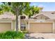 Charming villa with a two-car garage, well-maintained landscaping, and a classic Spanish tile roof at 6205 Miramonte Dr # 103, Orlando, FL 32835