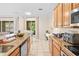 Open kitchen concept with long countertops, stainless steel appliances, seamlessly connecting to the dining and living spaces at 6205 Miramonte Dr # 103, Orlando, FL 32835