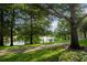 Scenic view of the lake with a fountain, mature trees, and a walking path creating a serene ambiance at 6205 Miramonte Dr # 103, Orlando, FL 32835