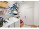 Functional laundry room with a washing machine, dryer, storage shelves, and access to the outside at 6205 Miramonte Dr # 103, Orlando, FL 32835