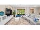 Spacious living room featuring plush carpeting, a modern entertainment center, and sliding glass doors to the backyard at 6205 Miramonte Dr # 103, Orlando, FL 32835