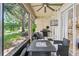 Relaxing screened patio with outdoor seating, ceiling fan, and serene views of the landscape at 6205 Miramonte Dr # 103, Orlando, FL 32835