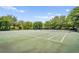 Outdoor tennis courts surrounded by mature trees, perfect for recreational play at 6205 Miramonte Dr # 103, Orlando, FL 32835