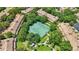 Aerial view of community tennis courts surrounded by lush greenery and residential buildings at 6205 Miramonte Dr # 103, Orlando, FL 32835