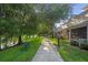 Picturesque walking path along the lakefront near the residences with mature trees and bench seating at 6205 Miramonte Dr # 103, Orlando, FL 32835