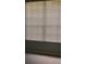 Bedroom featuring a window with window blinds, neutral carpet and light gray paint at 6304 Raleigh St # 204, Orlando, FL 32835