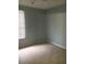 Bedroom featuring a window with window blinds, neutral carpet and light gray paint at 6304 Raleigh St # 204, Orlando, FL 32835
