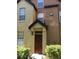 The home's entrance features a black awning and a brown front door at 6304 Raleigh St # 204, Orlando, FL 32835