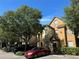 Two-story townhome with parking, landscaping, and exterior staircase at 6304 Raleigh St # 204, Orlando, FL 32835