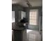 Kitchen with white cabinets, tile floor and black appliances at 6304 Raleigh St # 204, Orlando, FL 32835