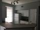 Bright kitchen featuring white cabinets and a breakfast bar at 6304 Raleigh St # 204, Orlando, FL 32835