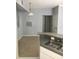 Open concept living room and kitchen with gray walls and granite countertops at 6304 Raleigh St # 204, Orlando, FL 32835