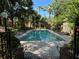 Large community pool surrounded by palm trees and lounge chairs, perfect for relaxation and recreation at 6304 Raleigh St # 204, Orlando, FL 32835