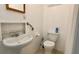 Standard bathroom features a white sink, toilet, and grab bars for accessibility at 714 Herbert St, Port Orange, FL 32129