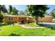 Charming single-story home with a well-maintained lawn and mature landscaping at 714 Herbert St, Port Orange, FL 32129