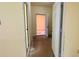 View down a hallway featuring a partially-open door and neutral paint at 714 Herbert St, Port Orange, FL 32129