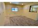 Open room with a window and new floors; ready to be transformed into your dream space at 714 Herbert St, Port Orange, FL 32129