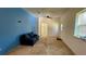 Living room with blue accent wall, ceiling fan, and a blue sofa at 714 Herbert St, Port Orange, FL 32129
