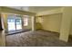 Bright living room featuring new wood-look flooring and sliding glass doors to the outside patio at 714 Herbert St, Port Orange, FL 32129