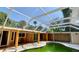 Backyard view of a screened-in pool surrounded by tropical landscaping at 714 Herbert St, Port Orange, FL 32129