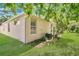 Backyard view with green grass, a tan home and a thriving landscape at 7900 Saint Giles Pl, Orlando, FL 32835