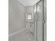 Bathroom featuring a glass shower enclosure and white tiled walls with granite vanity at 7900 Saint Giles Pl, Orlando, FL 32835