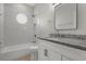 Bathroom with bathtub, shower, granite vanity, and tiled walls at 7900 Saint Giles Pl, Orlando, FL 32835
