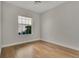 Bedroom featuring bamboo floors, light walls, and natural light from a window at 7900 Saint Giles Pl, Orlando, FL 32835