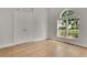 Bright bedroom with light wood floors, double door closet and large arched window at 7900 Saint Giles Pl, Orlando, FL 32835