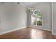 Empty dining room with beautiful hardwood floors, arched window, and classic chandelier at 7900 Saint Giles Pl, Orlando, FL 32835