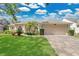 Inviting one-story home featuring a two-car garage and beautifully maintained landscaping at 7900 Saint Giles Pl, Orlando, FL 32835