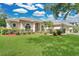 Lovely house with manicured lawn, mature trees, and colorful landscaping at 7900 Saint Giles Pl, Orlando, FL 32835